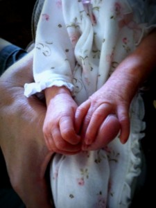 Annabelle's tiny hands holding my thumb